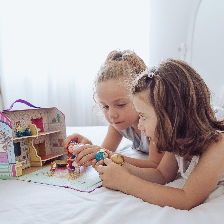 Duas crianças brincam ao faz de conta com a Casa de Bonecas portátil Tinyly Bluchka and Indie house da Djeco