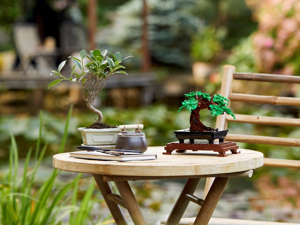 Modelo montado do LEGO 10281 Árvore Bonsai exposto numa mesa de jardim